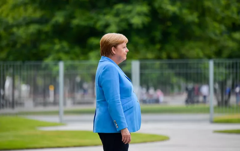 German Chancellor Angela Merkel greets an honour guard before the arrival of the Finnish Prime Minister at the Chancellery in Berlin on July 10, 2019. (Photo by Tobias SCHWARZ / AFP)