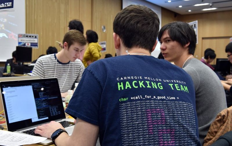 Some 90 participants in 24 teams from seven nations and regions from China, Japan, Poland, Russia, South Korea, Taiwan, and the United States compete in their hacking skills at the final rounds of the Security Contest 2014, SECCON on February 7, 2015.  A cyber security competition began in Tokyo, with organisers aiming to show off the skills of young Japanese hackers by seeing how they fare against foreign rivals.    AFP PHOTO / Yoshikazu TSUNO