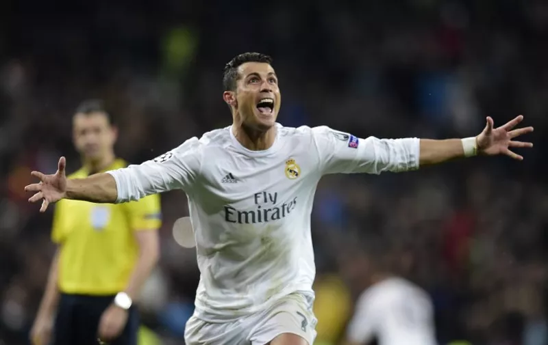 Real Madrid's Portuguese forward Cristiano Ronaldo celebrates after scoring his third goal during the Champions League quarter-final second leg football match Real Madrid vs Wolfsburg at the Santiago Bernabeu stadium in Madrid on April 12, 2016. / AFP PHOTO / JAVIER SORIANO