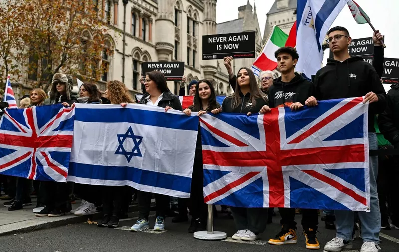 Protesters wave Israeli and Union Jack flags, during a demonstration in central London on November 26, 2023 to protest against antisemitism. (Photo by JUSTIN TALLIS / AFP)