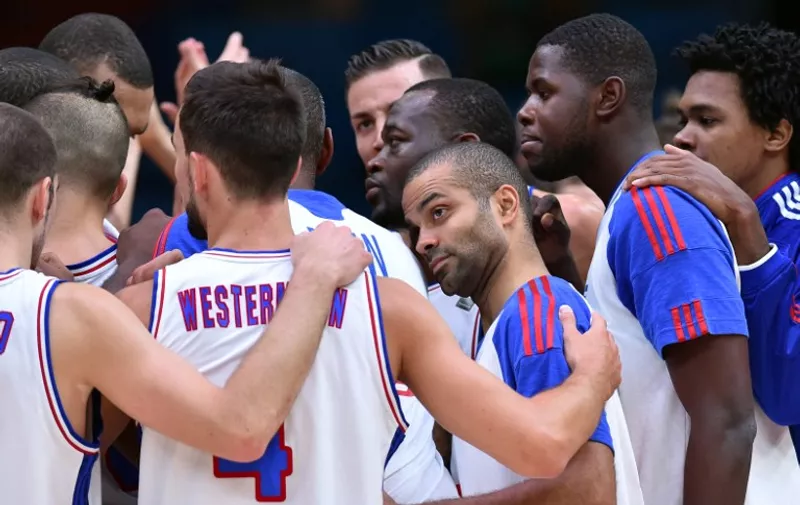 France's point guard Tony Parker (C-R) and his teammates celebrate after France defeated Latvia in their round of 8 basketball match at the EuroBasket 2015 in Lille, northern France, on September 15, 2015.    AFP PHOTO / PHILIPPE HUGUEN