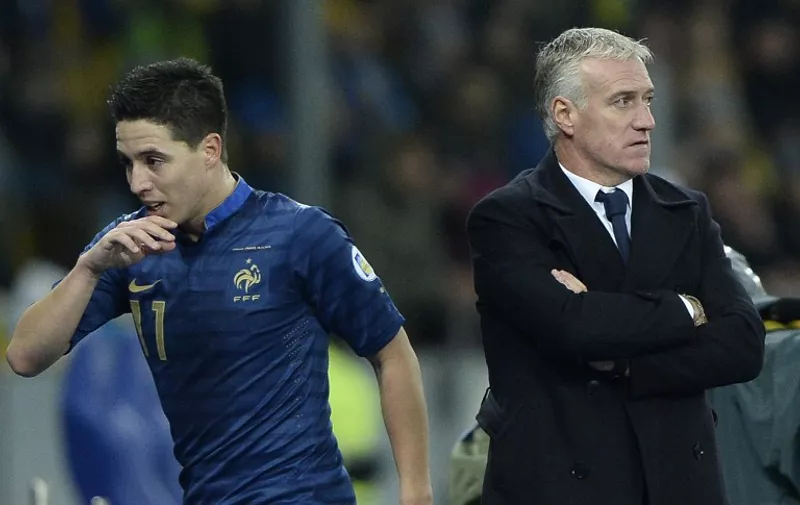 France's midfielder Samir Nasri (L) leaves the pitch next to France's head coach Didier Deschamps during the FIFA World Cup 2014 qualifying football match Ukraine vs France on November 15, 2013 at the Olympic stadium in Kiev.  AFP PHOTO / FRANCK FIFE