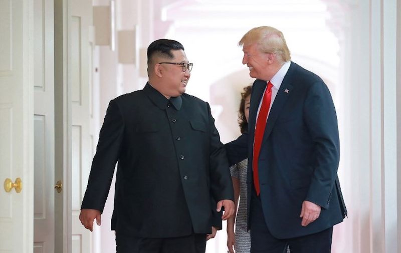 In this picture taken on June 12, 2018 and released from North Korea's official Korean Central News Agency (KCNA) on June 13, 2018, US President Donald Trump (R) and North Korea's leader Kim Jong Un (L) walk to attend their historic US-North Korea summit, at the Capella Hotel on Sentosa island in Singapore. / AFP PHOTO / KCNA VIA KNS / - / South Korea OUT / REPUBLIC OF KOREA OUT ---EDITORS NOTE--- RESTRICTED TO EDITORIAL USE - MANDATORY CREDIT "AFP PHOTO/KCNA VIA KNS" - NO MARKETING NO ADVERTISING CAMPAIGNS - DISTRIBUTED AS A SERVICE TO CLIENTS / THIS PICTURE WAS MADE AVAILABLE BY A THIRD PARTY. AFP CAN NOT INDEPENDENTLY VERIFY THE AUTHENTICITY, LOCATION, DATE AND CONTENT OF THIS IMAGE. /