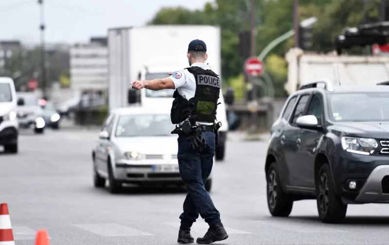 A police officer directs vehicles in Paris on August 1, 2020 during a major weekend of the French summer holidays. (Photo by STEPHANE DE SAKUTIN / AFP)