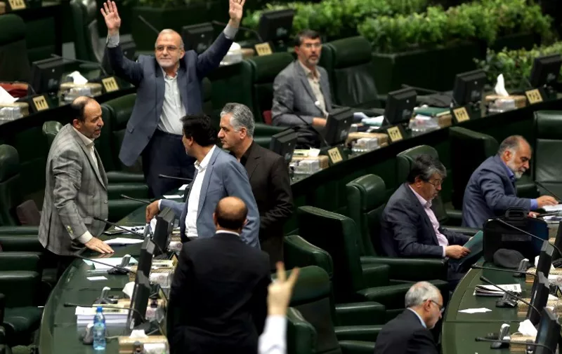 Iranian MP's attend a parliament session in Tehran, on March 1, 2016.  / AFP PHOTO / ATTA KENARE