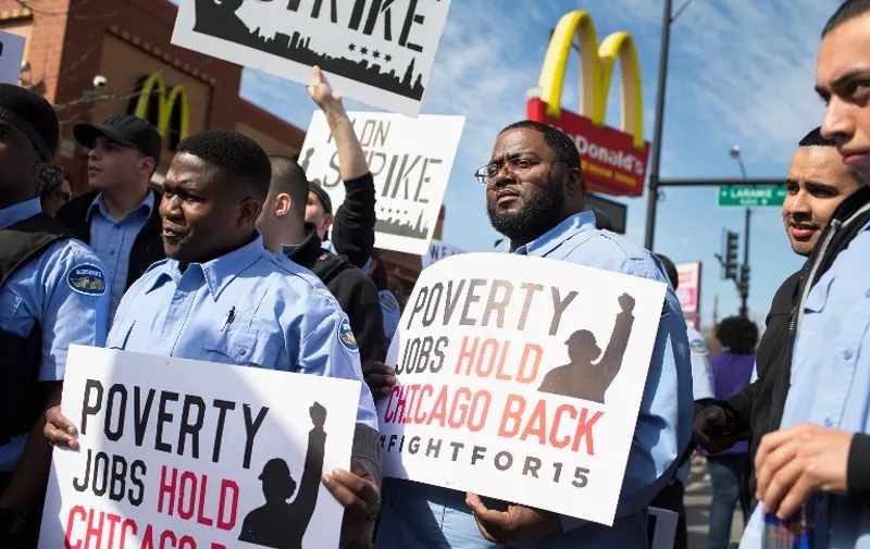 CHICAGO, IL - APRIL 15: Demonstrators gather in front of a McDonald's restaurant to call for an increase in minimum wage on April 15, 2015 in Chicago, Illinois. The demonstration was one of many held nationwide to draw attention to the cause.   Scott Olson/Getty Images/AFP