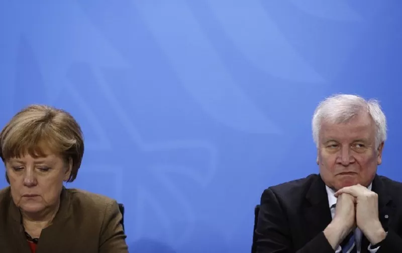 (FILES) In this file photo taken on April 14, 2016, German Chancellor Angela Merkel (L) and then Bavarian state premier and leader of the conservative Christian Social Union (CSU) Horst Seehofer give a press conference at the Chancellery in Berlin.
As German Chancellor Angela Merkel fights to save her government in a heated battle over immigration, a poll showed on June 15, 2018 most Germans support the tougher line of her rebel interior minister. The survey found that 62 percent were in favour of turning back undocumented asylum seekers at the border, in line with the stance of Interior Minister Horst Seehofer who is openly challenging Merkel. / AFP PHOTO / ODD ANDERSEN