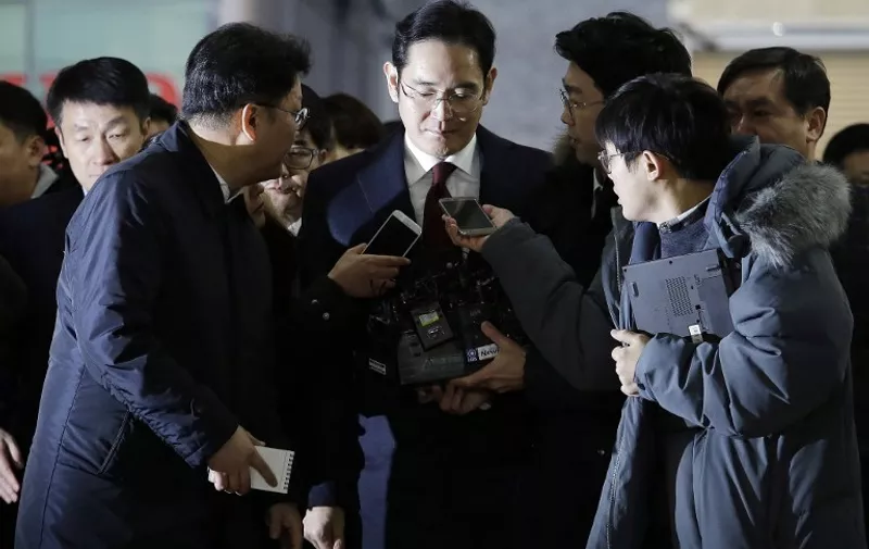 Lee Jae-yong (C) vice chairman of Samsung Electronics, arrives to be questioned as a suspect in a corruption scandal that led to the impeachment of President Park Geun-Hye, at the office of the independent counsel in Seoul on January 12, 2017.

 / AFP PHOTO / POOL / AHN Young-Joon