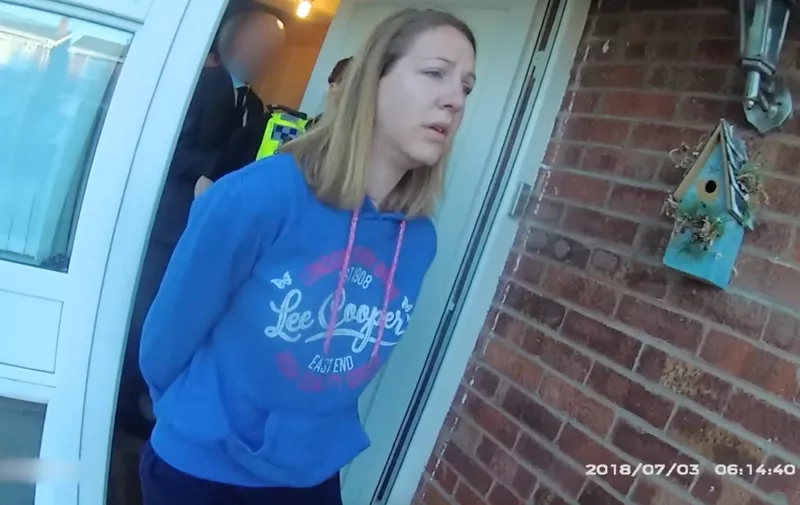 This is the moment when baby serial killer Lucy Letby was arrested at her Chester home in July 2018., Cheshire Police went to the Westbourne Road home on July 3, just after 6am, to arrest nurse Letby on suspicion of multiple counts of murder and attempted murder., Letby, 33, has been found guilty of murdering seven babies and attempting to murder six more at the Countess of Chester Hospital between June 2015 and June 2016, while working as a neonatal unit nurse, Images taken from police body-worn footage shows Letby, who had recently returned from a family holiday, opening the door and initially smiling before cops introduce themselves and enter the address., Further footage shows Letby being taken away from her home to a police car about 10 minutes later., Video shot July 3, 2018 and released to the media on August 18, 2023. , Editorial usage., Credit Cheshire Police / MEGA.
18 Aug 2023,Image: 798237667, License: Rights-managed, Restrictions: World Rights, Model Release: no, Pictured: Lucy Letby arrested by police at home in Chester on July 3, 2018 before being led to car by cops