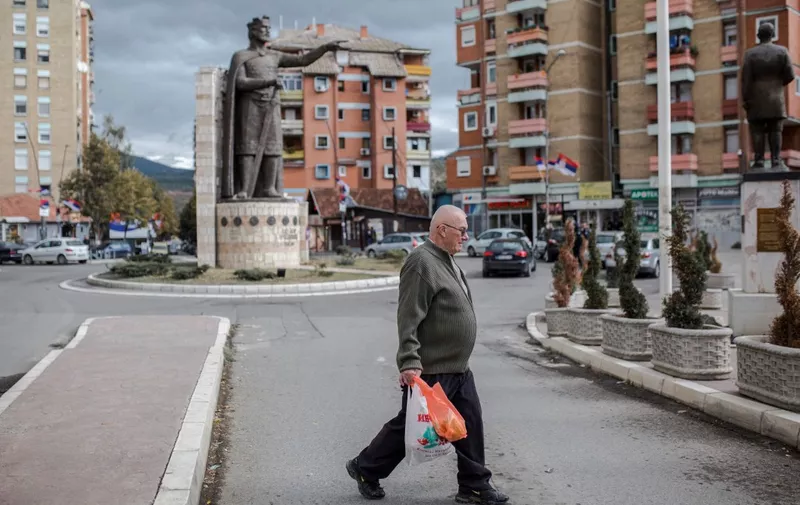 A man walks past the monument of late Serbian Duke Lazar, who was was killed in the Battle of Kosovo in June 1389, in the northern part of the divided city of Mitrovica on October 6, 2019. - Kosovo went to the polls on October 6, 2019 in an election that could usher in new leadership at a time when stalled talks with former war foe Serbia are a source of instability in Europe. (Photo by Vladimir Zivojinovic / AFP)