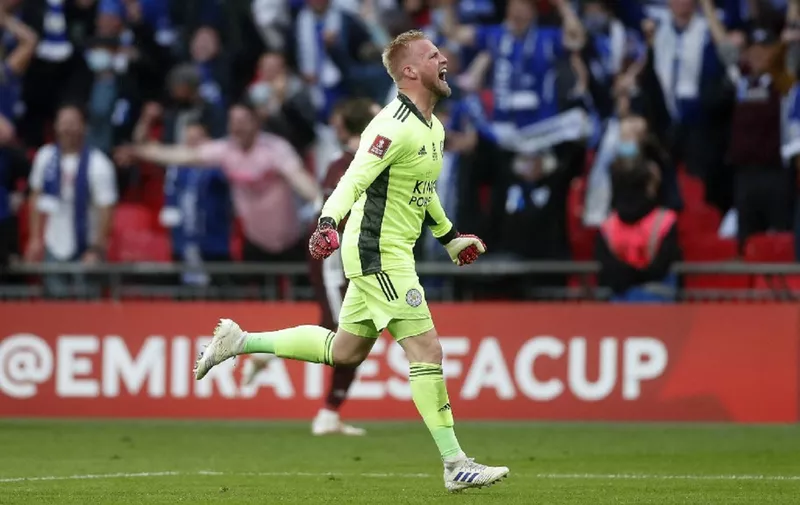 Leicester City's Danish goalkeeper Kasper Schmeichel celebrates victory after the English FA Cup final football match between Chelsea and Leicester City at Wembley Stadium in north west London on May 15, 2021. - Leicester won the FA Cup for the first time in the club's 137-year history as Youri Tielemans's sensational strike beat Chelsea 1-0 in front of 22,000 fans at Wembley. (Photo by MATTHEW CHILDS / POOL / AFP) / NOT FOR MARKETING OR ADVERTISING USE / RESTRICTED TO EDITORIAL USE