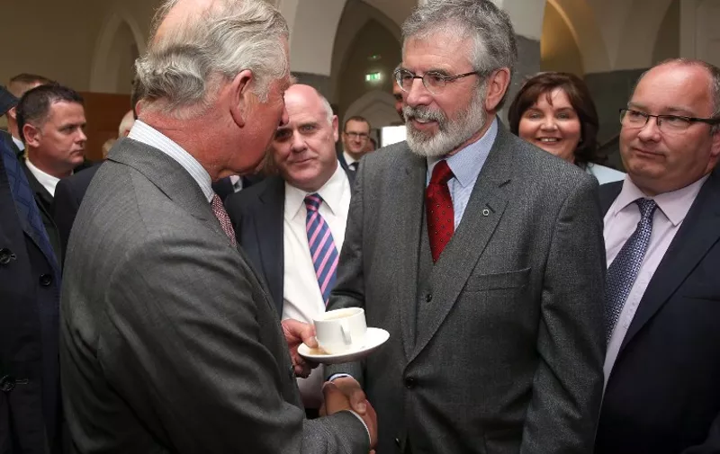 Britain's Prince Charles, Prince of Wales (L) shakes hands with Republican party Sinn Fein leader, Gerry Adams at the National University of Ireland in Galway, Ireland on May 19, 2015, on the first day of his visit to the country. Prince Charles became the first British royal to meet with Northern Irish republican leader Gerry Adams on an historic visit Tuesday aimed at promoting peace and reconciliation.  AFP PHOTO / POOL / BRIAN LAWLESS