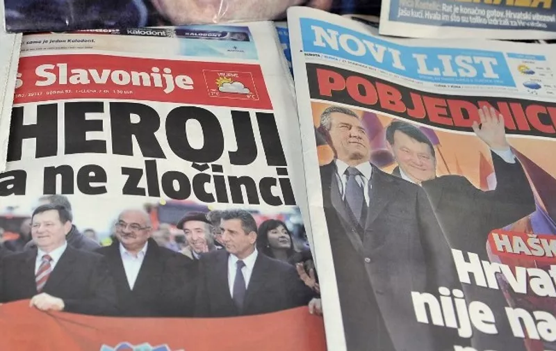 The front pages of the main Croatian daily newspapers baring pictures of former Croatian generals Ante Gotovina and  Mladen Markac are displayed on November 17, 2012 in Zagreb a day after their return to Croatia after they were freed by the UN war crimes tribunal, with many feeling the verdict vindicated Zagreb's role in the 1991-95 war against Belgrade-backed rebel Serbs. The court cleared them of committing crimes against Croatian Serbs during the bloody break-up of Yugoslavia. Many here see the ruling as confirmation that they fought a justified war.      AFP PHOTO/HRVOJE POLAN (Photo by HRVOJE POLAN / AFP)