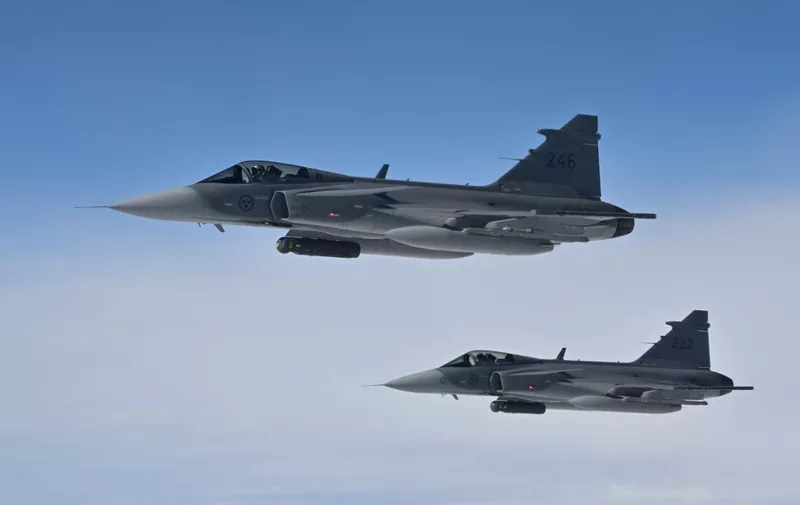 Swedish Air Force Saab JAS 39 Gripen jetfighters take part in the NATO exercise as part of the NATO Air Policing mission, in Alliance members sovereign airspace on July 4, 2023. (Photo by John THYS / AFP)