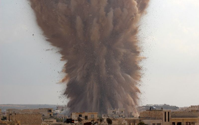 A picture taken on October 14, 2014 shows a large explosion allegedly hitting a Syrian army military outpost in the southern part of the city of Maarat al-Numan in the Idlib province. The explosion was reportedly caused by rebel fighters belonging to Ahrar al-Sham brigade of the Islamic Front coalition who dugged a tunnel underneath the outpost and loaded it with explosives.  AFP PHOTO / AL-MAARRA TODAY / GHAITH OMRAN / AFP / AL-MAARRA TODAY / GHAITH OMRAN