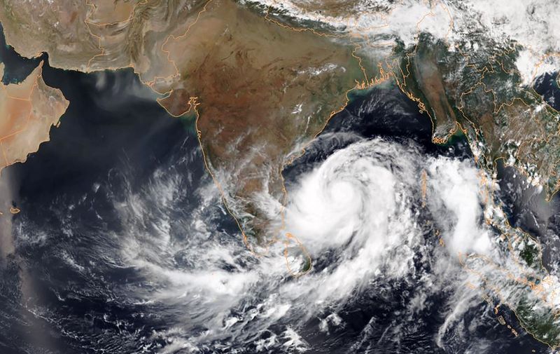 This May 1, 2019, satellite image obtained courtesy of the National Oceanic and Atmospheric Administration (NOAA) shows Tropical Cyclone Fani intensifying in the Bay of Bengal. - India deployed emergency personnel May 1, 2019, and ordered the navy on standby as it braced for an extremely severe cyclonic storm barrelling towards the eastern coast. Tropical Cyclone Fani, located in the Bay of Bengal and packing wind speeds up to 205 kilometres (127 miles) per hour, is expected to make landfall at Odisha state Friday. (Photo by HO / NOAA / AFP) / RESTRICTED TO EDITORIAL USE - MANDATORY CREDIT "AFP PHOTO / NOAA" - NO MARKETING NO ADVERTISING CAMPAIGNS - DISTRIBUTED AS A SERVICE TO CLIENTS ---