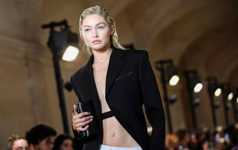 US model Gigi Hadid presents a creation for the Victoria Beckham Spring-Summer 2023 fashion show during the Paris Womenswear Fashion Week, in Paris, on September 30, 2022. (Photo by JULIEN DE ROSA / AFP)