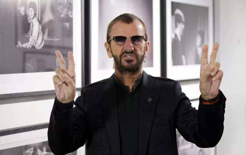 British musician Ringo Starr of legendary band The Beatles poses in front of an exhibition of photographs he took during his life during a photo call to promote his new book entitled "photograph" at the National Portrait Gallery in London on September 9, 2015. The book gives an insight into Starr's life through rare and previously unseen photographs taken by the musician that document his childhood, The Beatles and his travels.   AFP PHOTO / JUSTIN TALLIS / AFP PHOTO / JUSTIN TALLIS