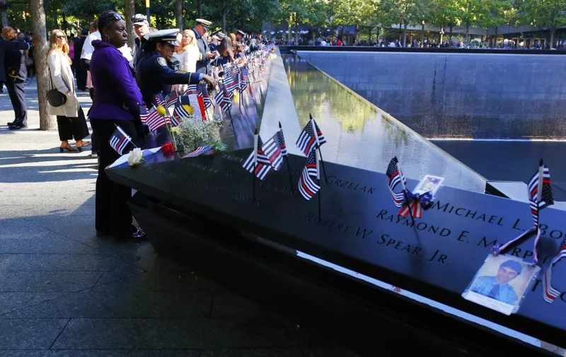 NEW YORK, NEW YORK - SEPTEMBER 11: People attend the annual 9/11 Commemoration Ceremony at the National 9/11 Memorial and Museum on September 11, 2021 in New York City. During the ceremony, six moments of silence were held, marking when each of the World Trade Center towers was struck and fell and the times corresponding to the attack on the Pentagon and the crash of Flight 93. The nation is marking the 20th anniversary of the terror attacks of September 11, 2001, when the terrorist group al-Qaeda flew hijacked airplanes into the World Trade Center, Shanksville, PA and the Pentagon, killing nearly 3,000 people.   Michael M. Santiago/Getty Images/AFP (Photo by Michael M. Santiago / GETTY IMAGES NORTH AMERICA / Getty Images via AFP)