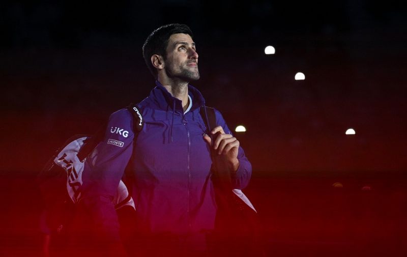 (FILES) In this file photo taken on November 20, 2021 Serbia's Novak Djokovic arrives for his first round singles match of the ATP Finals against Britain's Cameron Norrie at the Pala Alpitour venue in Turin. - Tennis superstar Novak Djokovic's legal battle to stay in Australia and chase a record 21st Grand Slam opened on January 10, 2022, but online access to media was delayed by a computer glitch, a court spokesman said. (Photo by Marco Bertorello / AFP)