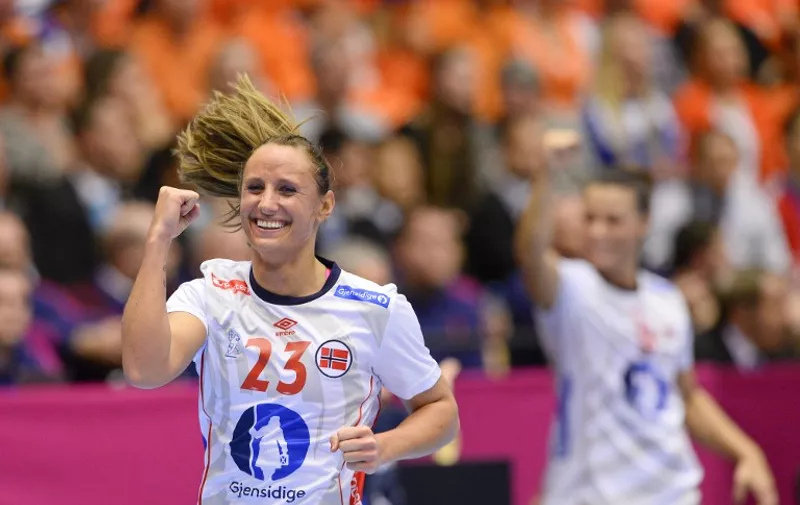 Norways Camilla Herrem (L) celebrates after scoring a goal during the 2015 Women's Handball World Championship final match between the Netherlands and Norway in Herning, Denmark on December 20, 2015.  / AFP / JONATHAN NACKSTRAND