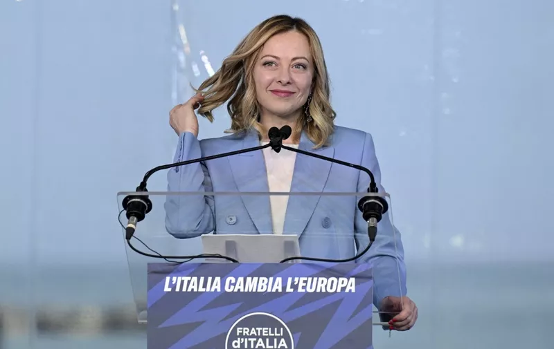 Italy's Prime Minister, Giorgia Meloni smiles on stage during the campaign meeting of the far-right party Fratelli d'Italia (Brothers of Italy) ahead of the European Elections, on April 28, 2024 in Pescara. (Photo by Tiziana FABI / AFP)