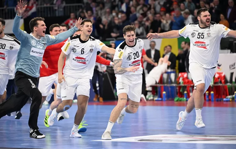 Austria's team celebrates after the men's EURO 2024 EHF Handball European Championship match Group B Spain v Austria in Mannheim, western Germany on January 16, 2024. (Photo by Kirill KUDRYAVTSEV / AFP)