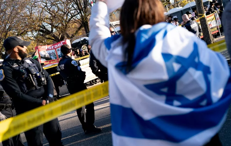 Anti-Zionist Orthodox Jews stand behind police tape as demonstrators in support of Israel gather to denounce antisemitism and call for the release of Israeli hostages, on the National Mall in Washington, DC, on November 14, 2023. Thousands of civilians, both Palestinians and Israelis, have died since October 7, 2023, after Palestinian Hamas militants based in the Gaza Strip entered southern Israel in an unprecedented attack triggering a war declared by Israel on Hamas with retaliatory bombings on Gaza. (Photo by Stefani Reynolds / AFP)