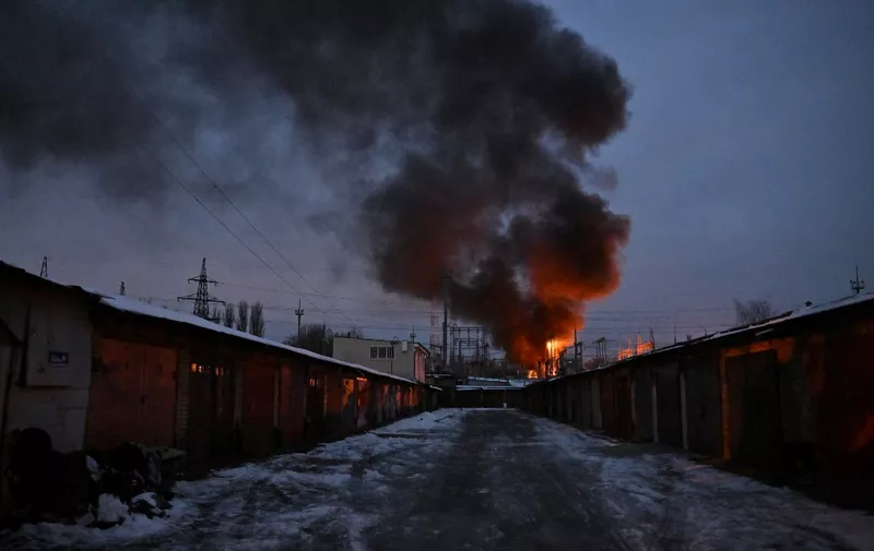 This photograph shows an object of a critical power infrastructure as it burns after a drone attack to Kyiv, amid the Russian invasion of Ukraine. - Drones attacked the Ukrainian capital early on December 19, 2022 morning, the Kyiv city military administration said, urging people to heed air alerts. (Photo by Sergei SUPINSKY / AFP)