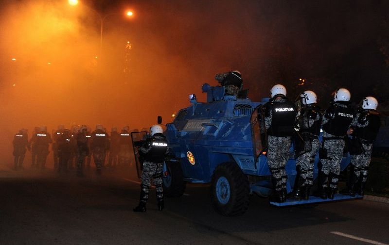 Montenegrin riot police take position during clashes with anti-government protesters in the capital Podgorica on October 24, 2015. Police in Montenegro's capital Podgorica fired tear gas to disperse several thousand people who rallied demanding the resignation of Prime Minister Milo Djukanovic, the third such clash in a week. AFP PHOTO / SAVO PRELEVIC / AFP PHOTO / SAVO PRELEVIC