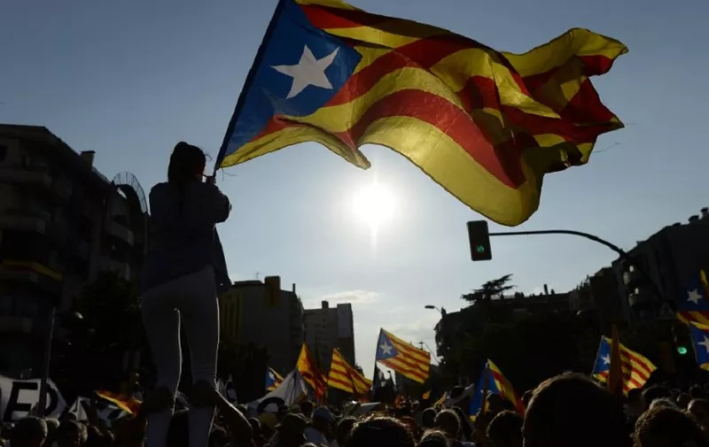 People wave 'Esteladas' (pro-independence Catalan flags) as they gather during a pro-independence demonstration, on September 11, 2016, in Barcelona during the National Day of Catalonia 'Diada'.
The 'Diada' marks the date (September 11, 1714) when Barcelona fell to Spanish and French forces in the War of Succession, that redrew the map of Spain. Tens of thousands of Catalans gathered in Barcelona and four other cities today for mass rallies to demand their region break away from Spain, as pro-independence leaders try to iron out differences over a secession plan.

 / AFP PHOTO / JOSEP LAGO