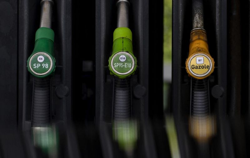 This picture taken on June 8, 2022 shows gasoline nose units at a petrol station in Quimper, Brittany, western France, as gasoline prices reached record levels last week in France, above the 2 euros, despite the rebate at the pump put in place by the government, said the Ministry of Ecological Transition. (Photo by FRED TANNEAU / AFP)