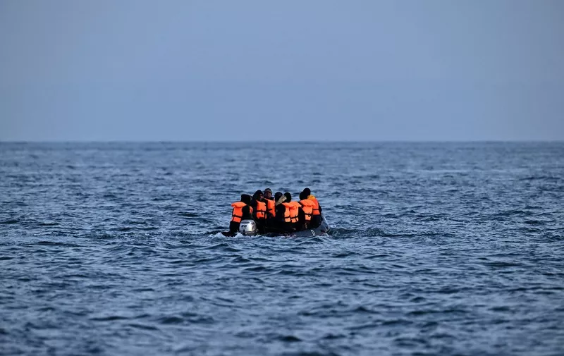 Migrants travel in an inflatable boat across the English Channel, bound for Dover on the south coast of England. - More than 45,000 migrants arrived in the UK last year by crossing the English Channel on small boats. (Photo by Ben Stansall / AFP)