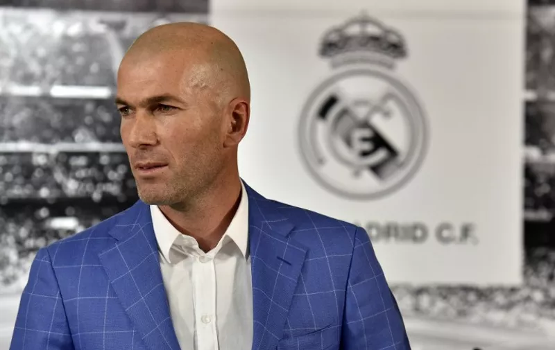 Real Madrid's new French coach Zinedine Zidane poses after a statement of Real Madrid's president at the Santiago Bernabeu stadium in Madrid on January 4, 2016. Rafael Benitez's unhappy reign in charge of Real Madrid came to an end after just seven months and 25 games when he was sacked and replaced by club legend Zinedine Zidane today.   AFP PHOTO/ GERARD JULIEN / AFP / GERARD JULIEN