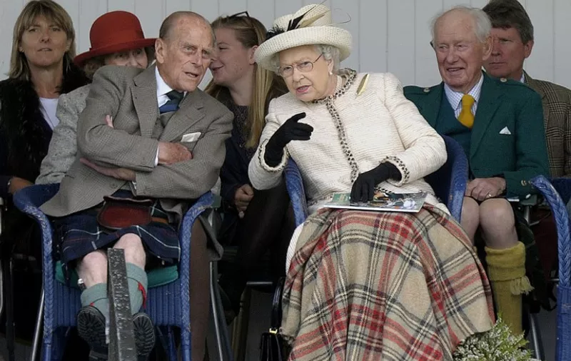 (FILES) This file photo taken on September 06, 2014 shows Britain's Queen Elizabeth II and her husband Prince Philip (L) attending the Braemar Gathering in Braemar, central Scotland.
Britain's Prince Philip, the 95-year-old husband of Queen Elizabeth II, will retire from public engagements later this year, Buckingham Palace said on May 4, 2017. / AFP PHOTO / Andy Buchanan