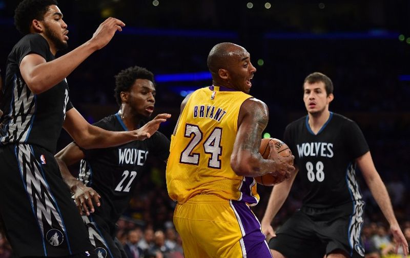 LOS ANGELES, CA - OCTOBER 28: Kobe Bryant #24 of the Los Angeles Lakers spins from Karl-Anthony Towns #32, Andrew Wiggins #22 and Nemanja Bjelica #88 of the Minnesota Timberwolves during the first quarter at Staples Center on October 28, 2015 in Los Angeles, California. NOTE TO USER: User expressly acknowledges and agrees that, by downloading and or using this Photograph, user is consenting to the terms and condition of the Getty Images License Agreement.   Harry How/Getty Images/AFP