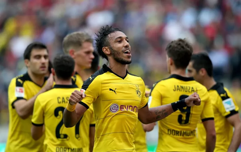 Dortmund's Gabonese striker Pierre-Emerick Aubameyang (C) celebrates after scoring his team's fourth goal during the German first division Bundesliga football match Hannover 96 v Borussia Dortmund, in Hannover, on September 12, 2015.  AFP PHOTO /  RONNY HARTMANN

RESTRICTIONS: DURING MATCH TIME: DFL RULES TO LIMIT THE ONLINE USAGE TO 15 PICTURES PER MATCH AND FORBID IMAGE SEQUENCES TO SIMULATE VIDEO. 
== RESTRICTED TO EDITORIAL USE ==
FOR FURTHER QUERIES PLEASE CONTACT DFL DIRECTLY AT + 49 69 650050.