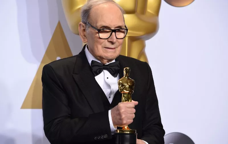 Composer Ennio Morricone poses with the Oscar for Best Original Score, "The Hateful Eight," in the press room during the 88th Oscars in Hollywood on February 28, 2016.     / AFP / Robyn BECK