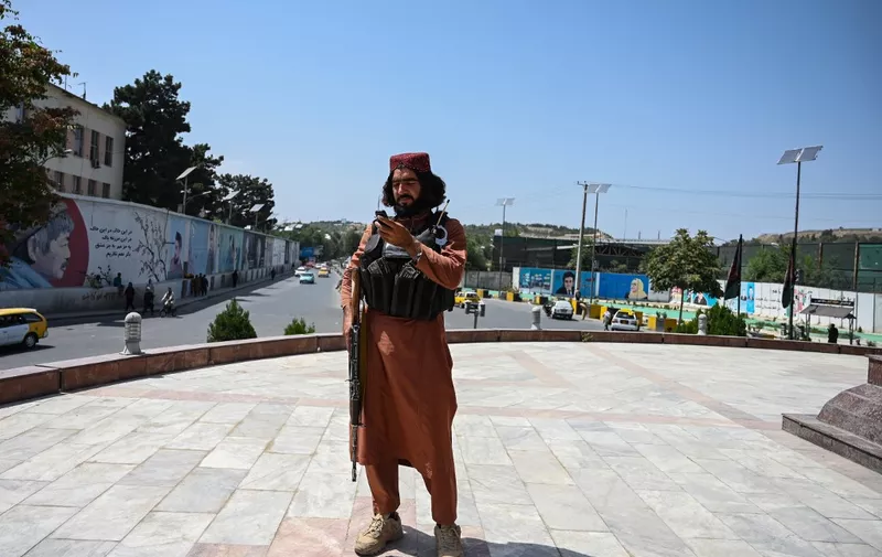 A Taliban fighter stands guard at the Massoud Square in Kabul on August 16, 2021. (Photo by Wakil Kohsar / AFP)