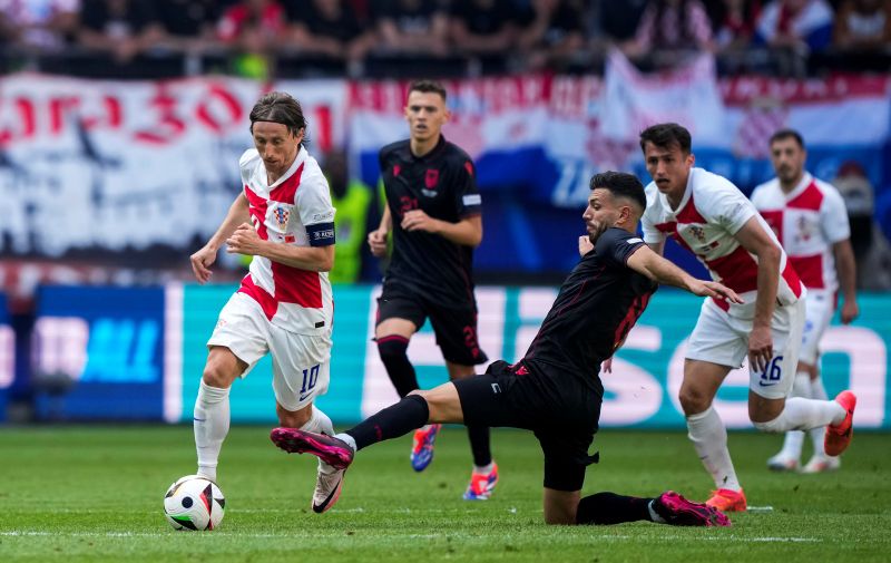 Croatia's Luka Modric, left, vibes for the ball with Albania's Klaus Gjasula during a Group B match between Croatia and Albania at the Euro 2024 soccer tournament in Hamburg, Germany, Wednesday, June 19, 2024. The match ended in a 2-2 draw. (AP Photo/Ebrahim Noroozi)