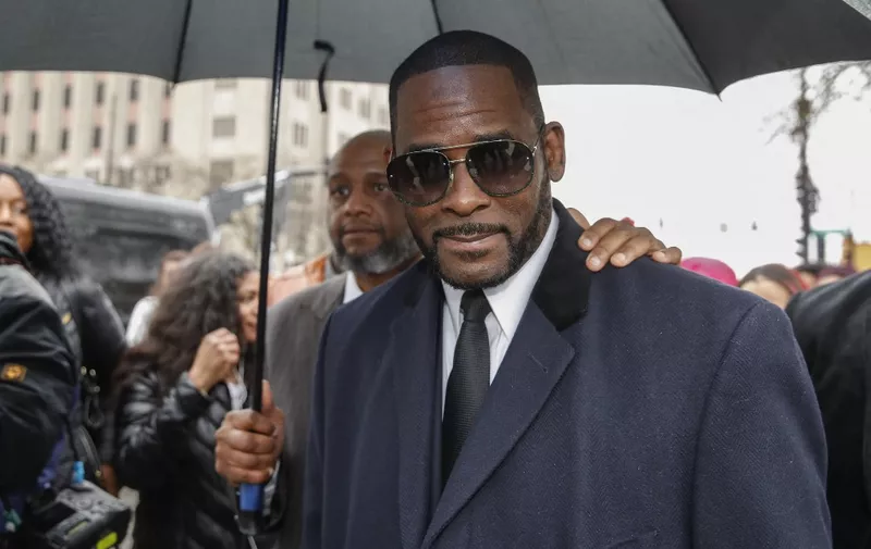 (FILES) In this file photo taken on May 07, 2019, R. Kelly leaves the Leighton Criminal Court Building after a hearing on sexual abuse charges in Chicago, Illinois. - R. Kelly is a "predator" who used his fame to groom minors for sex, prosecutors told a New York court as the disgraced R&amp;B superstar's much-anticipated trial got underway on August 18, 2021. The Grammy-winning artist -- wearing a gray suit, purple tie, and glasses -- sat silently, his head down at times as the prosecution opened its case by detailing a pattern of violent abuse. (Photo by KAMIL KRZACZYNSKI / AFP)