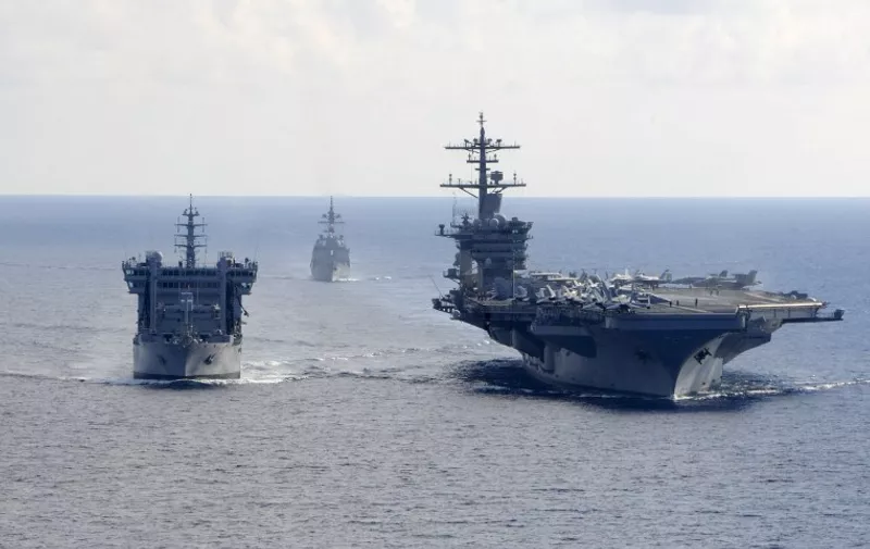 In this October 18, 2015 US Navy handout photo, the aircraft carrier USS Theodore Roosevelt (CVN 71) transits alongside the Indian Deepak-class fleet tanker INS Shakti (L) (A 57) during a replenishment-at-sea exercise as Japanese Maritime Self-defense Force Akizuki-class destroyer JS Fuyuzuki (DD-118) approaches during Exercise Malabar 2015. Malabar is a continuing series of complex, high-end war fighting exercises conducted to advance multi-national maritime relationships and mutual security.   AFP PHOTO / HANDOUT  / US NAVY / MCS CHAD M. TRUDEAU           == RESTRICTED TO EDITORIAL USE / MANDATORY CREDIT: "AFP PHOTO / HANDOUT / US NAVY / MCS CHAD M. TRUDEAU  "/ NO MARKETING / NO ADVERTISING CAMPAIGNS / DISTRIBUTED AS A SERVICE TO CLIENTS == / AFP PHOTO / US NAVY / MCS CHAD M. TRUDEAU