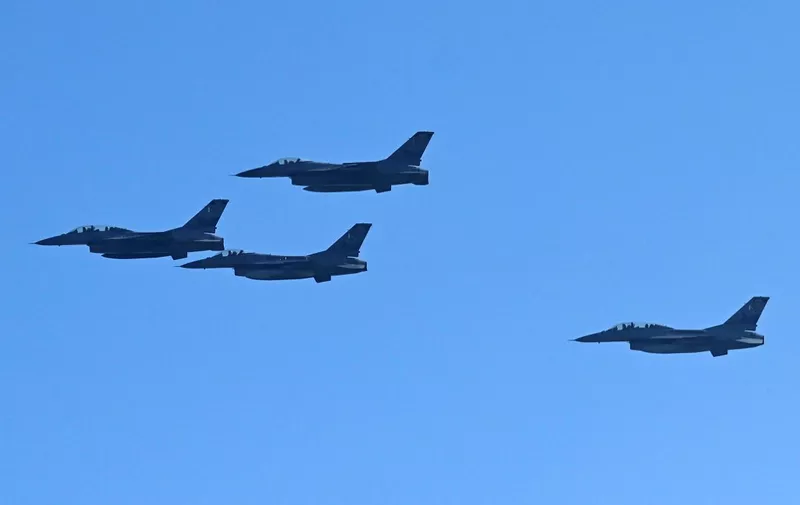 Pakistan Air Force F-16 fighter jets perform a flypast during a rehearsal ahead of Pakistan's Day parade on March 23, in Islamabad on March 16, 2022. (Photo by Aamir QURESHI / AFP)