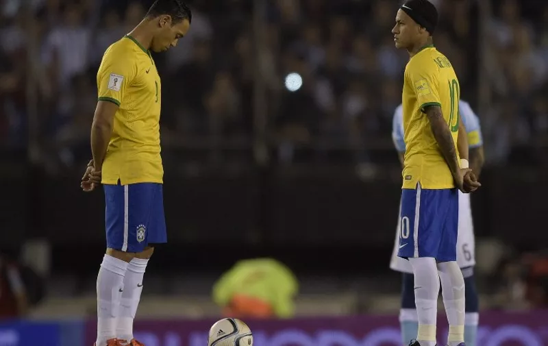 Brazilian football team players Brazil's Ricardo Oliveira (L) and Brazil's Neymar Jr. attend a minute of silence in honor of victims of attacks that left at least 120 dead in France, before their Russia 2018 FIFA World Cup South American Qualifiers football match against Argentina, in Buenos Aires, on November 13, 2015.  AFP PHOTO / EITAN ABRAMOVICH