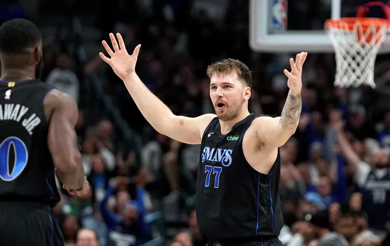 Dallas Mavericks guard Luka Doncic celebrates with teammates during the second half of an NBA basketball game against the LA Clippers in Dallas, Friday, Nov. 10, 2023. (AP Photo/LM Otero)