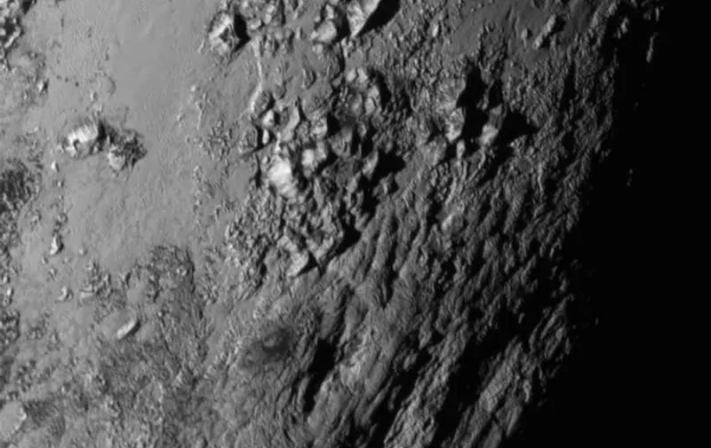 This July 15, 2015 image from NASA shows aclose-up image of a region near Plutos equator reveal a giant surprise: a range of youthful mountains rising as high as 11,000 feet (3,500 meters) above the surface of the icy body. The mountains likely formed no more than 100 million years ago -- mere youngsters relative to the 4.56-billion-year age of the solar system -- and may still be in the process of building, says Jeff Moore of New Horizons Geology, Geophysics and Imaging Team (GGI). That suggests the close-up region, which covers less than one percent of Plutos surface, may still be geologically active today. The New Horizons interplanetary space probe completed its closest approach fly-by of Pluto July 14 making the United States the first to explore the dwarf planet. AFP PHOTO / HANDOUT / NASA                 == RESTRICTED TO EDITORIAL USE / MANDATORY CREDIT: "AFP PHOTO / HANDOUT / NASA  "/ NO MARKETING / NO ADVERTISING CAMPAIGNS / NO A LA CARTE SALES / DISTRIBUTED AS A SERVICE TO CLIENTS ==