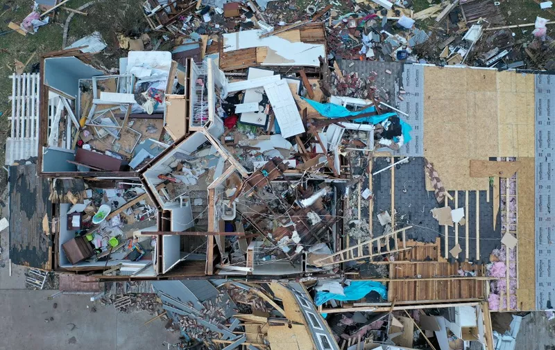 MAYFIELD, KENTUCKY - DECEMBER 11: An aerial view of debris scattered around a home destroyed by a tornado on December 11, 2021 in Mayfield, Kentucky. Multiple tornadoes touched down in several midwestern states late Friday evening causing widespread destruction and leaving an estimated 70-plus people dead.   Scott Olson/Getty Images/AFP (Photo by SCOTT OLSON / GETTY IMAGES NORTH AMERICA / Getty Images via AFP)