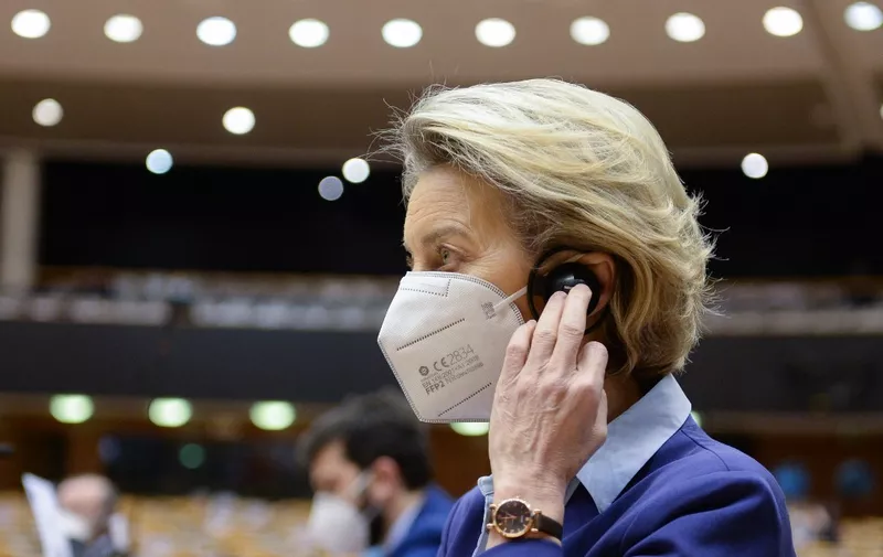European Commission President Ursula Von Der Leyen adjusts her earphone during a debate on the European Union's vaccine strategy at the European Parliament in Brussels, on February 10, 2021. - Leaders of the European Union have been engaged in bitter public rows with pharmaceutical firms over supply shortages, as they faced public anger and scrutiny over slow vaccination rollouts in member states. (Photo by JOHANNA GERON / POOL / AFP)