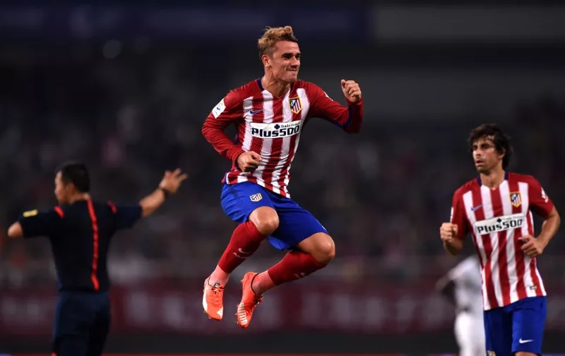 Atletico Madrid's French forward Antoine Griezmann (C) celebrates his second goal during a friendly football match between Shanghai SIPG and Atletico Madrid in Shanghai on August 4, 2015. AFP PHOTO / JOHANNES EISELE