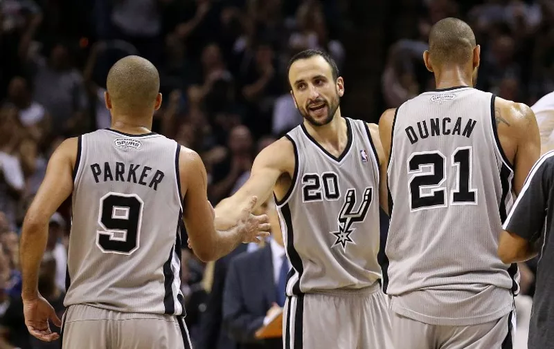 SAN ANTONIO, TX - MAY 21: (L-R) Tony Parker #9, Manu Ginobili #20 and Tim Duncan #21 of the San Antonio Spurs celebrate a play as they walk to the bench during a timout in overtime against the Memphis Grizzlies during Game Two of the Western Conference Finals of the 2013 NBA Playoffs at AT&amp;T Center on May 21, 2013 in San Antonio, Texas.   Stephen Dunn/Getty Images/AFP